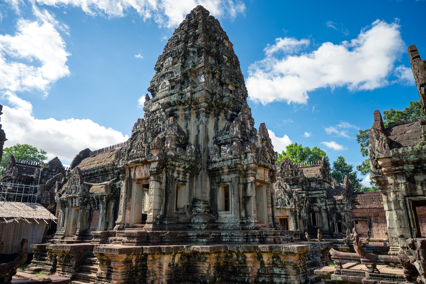 Ancient Angkor Wat temple in Siem Reap, Cambodia, under a bright blue sky.